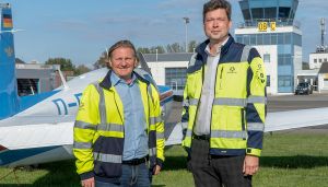 Marcus Breuer and André Bender in front of airport tower