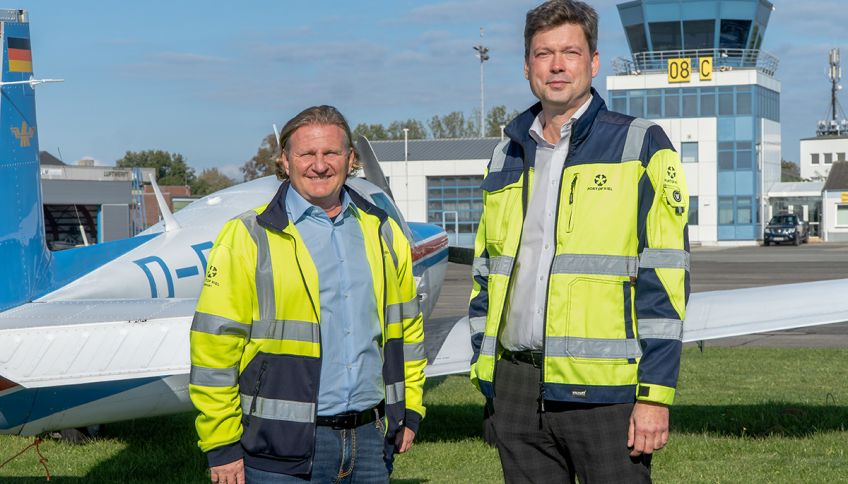 Marcus Breuer and André Bender in front of airport tower