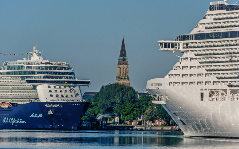 Town hall tower between two cruise ships